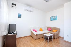 - un salon avec un canapé et une télévision dans l'établissement Apartments by the sea Stupin Celine, Rogoznica - 21279, à Rogoznica