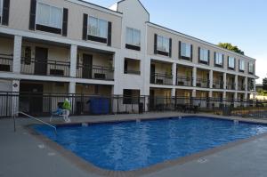 a building with a swimming pool in front of a building at Days Inn by Wyndham Marietta-Atlanta-Delk Road in Marietta