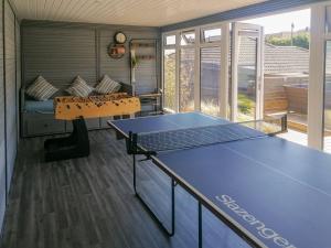 a room with a ping pong table in it at Palm View in Paignton
