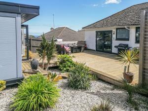 a wooden deck in the backyard of a house at Palm View in Paignton