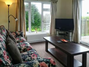 a living room with a couch and a coffee table at Apple Blossom in Saint Ervan