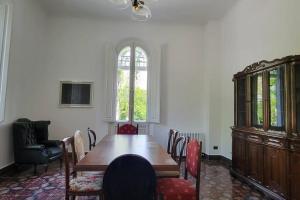 a dining room with a table and chairs and a window at Amazing Villa in Migliarino in Migliarino