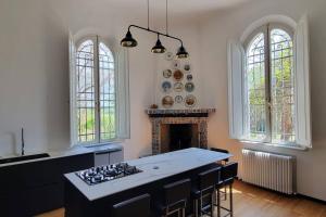 a kitchen with a stove and a fireplace at Amazing Villa in Migliarino in Migliarino