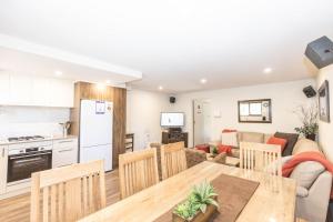 cocina y sala de estar con mesa y sillas en Lake Pines 2 of 24 Cobbon Crescent Free WiFi and Stay 7 nights only pay 6 en Jindabyne
