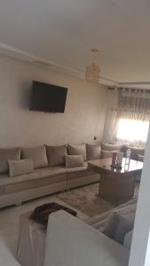 a living room with a couch and a table at Nador Jadid Hay AL Matar 10 6 in Nador