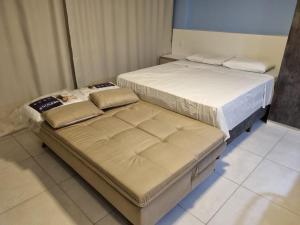 two beds sitting next to each other in a room at Wind Palace Residence in Cabedelo +18 photos