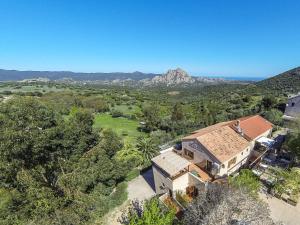an aerial view of a house with a mountain in the background at Relais de Saleccia in Casta