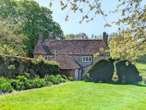 an old house with a garden in front of it at Holme Street House and Dove Cote Lodge in Pulborough