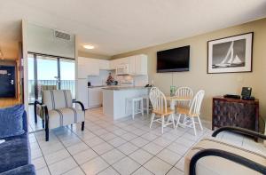 a kitchen and living room with a table and chairs at 0610 Smooth Sailing by Atlantic Towers in Carolina Beach