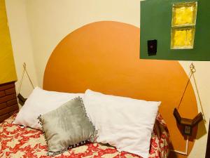 a bedroom with a bed with a pillow on it at El rincón de la Escandón in Mexico City