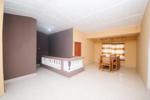 an empty room with a table and chairs at BERG'S BEACH HOUSE in Winneba