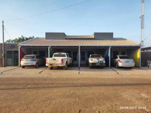 a group of cars parked in front of a building at FlatsMedrado Hotel in Confresa