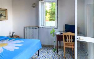 a bedroom with a bed and a desk and a window at 1 Bedroom Lovely Home In Barano Dischia in Ischia