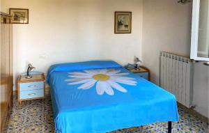 a bedroom with a blue bed with a flower on it at 1 Bedroom Lovely Home In Barano Dischia in Ischia
