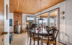 a dining room with a table and chairs at Awesome Home In Fårevejle With Wifi in Fårevejle