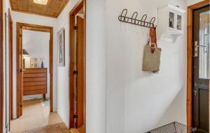 a hallway with a white wall with a bag hanging on it at Awesome Home In Fårevejle With Wifi in Fårevejle