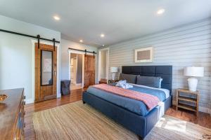 a bedroom with a blue bed in a room at The Benny-1 2 mi to Slaughter Pen Trails in Bentonville