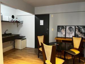 a kitchen and dining room with a table and chairs at Abdon Batista - Apto completo central, Smart TV in Joinville +41 photos
