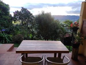 a wooden table and two chairs on a patio at La Casita de Chocolate 3 in Bogotá