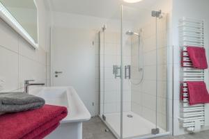 a bathroom with a shower and a sink at Ostfreesenhuus - Westwind in Aurich +25 photos