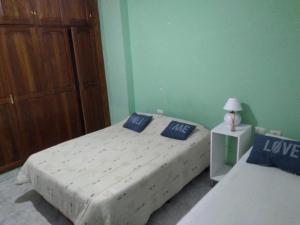a bedroom with two beds with blue pillows and a closet at Departamento Familiar Amplio y cómodo in Santiago del Estero