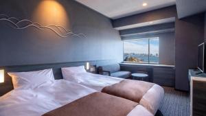 a hotel room with a large bed and a window at La Vista Tokyo Bay in Tokyo