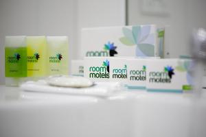 a bathroom counter with two bottles of toiletries on it at Room Motel Kingaroy East in Kingaroy