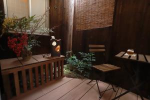 a balcony with a table and a bench with plants at Kyo KOZO Kitano Tenjin - Vacation STAY 89906 in Kyoto