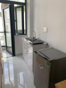 a kitchen with a sink and a counter at Hoang Hoa Tham Apartment in Nha Trang