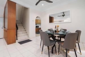 a dining room with a black table and chairs at Welcome to Happy 35, Old Klang Road, 10mins to Midvalley ! in Kuala Lumpur