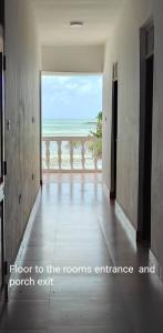 a hallway with a room with a view of the ocean at Villa Mina beachhouse in Jambiani
