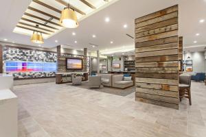 an office lobby with a wooden accent wall at SpringHill Suites by Marriott Huntington Beach Orange County in Huntington Beach