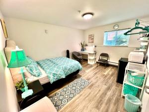 a bedroom with a bed and a desk and a table at Studio Apartment with Shared Bathroom 10 minutes walk to University of WA in Seattle