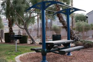 a playground with two benches and a blue pole at Gorgeous home away from home in Las Vegas