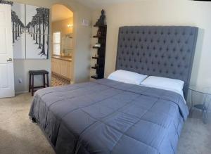 um quarto com uma cama grande e um cobertor azul em Gorgeous home away from home em Las Vegas