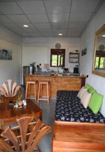 a room with a couch and a table and a kitchen at Gray house up in Weligama