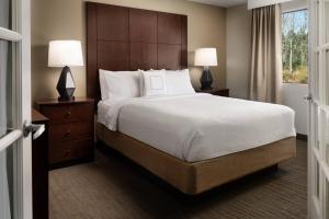 a bedroom with a bed and two lamps and a window at Residence Inn Seattle North/Lynnwood Everett in Lynnwood
