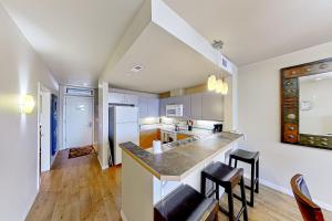 a kitchen with a counter and some chairs in it at Chelan Resort Suites Sunny Livin 111 in Chelan