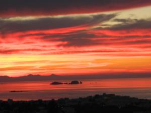 a sunset over the ocean with a red sky at Sunset View Hotel in Parikia