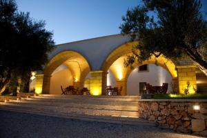 a building with arches and stairs and a stone wall at Agriturismo Amaranto in Marina di Pescoluse
