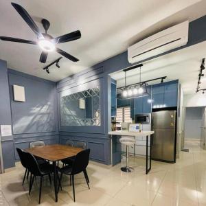 a dining room with a table and a ceiling fan at Wallaway2stay Kiara Nilai Apartment 3 Bedroom in Nilai