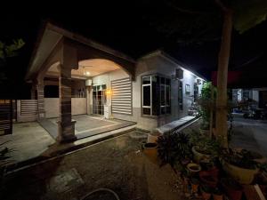 a house at night with a lit up front yard at GS24 Muar in Muar