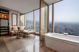 a bathroom with a tub and a living room with a view at The Ritz-Carlton, Nanjing in Nanjing