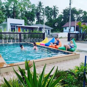 a group of people in the pool at a resort at BSK Bungalows in Lipa Noi