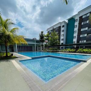 a large swimming pool in front of a building at Wallaway2stay Kiara Nilai Apartment 3 Bedroom in Nilai