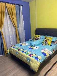 a bedroom with a bed with hello kitty pillows on it at Triple H Minionstay Kuala Terengganu in Kuala Terengganu