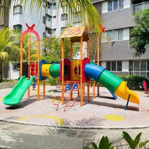 a playground with a slide in front of a building at Wallaway2stay Kiara Nilai Apartment 3 Bedroom in Nilai