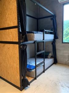 a room with two bunk beds with a window at COOLFREEDIVING Hostel in Green Island