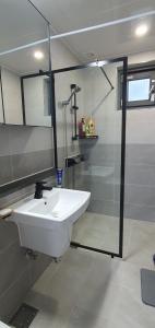 a bathroom with a sink and a glass shower at High-Quality House Ocean view in Tongyeong