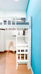 a bunk bed with a desk and a chair in a room at Shared Apartment Lockhart Road 384 in Hong Kong